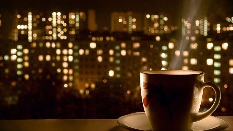 Cafe đêm muộn trước khung cảnh thành phố xa