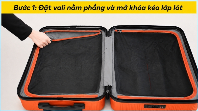 Đặt vali nằm chắc chắn và mở khóa kéo của lớp lót bên trong
