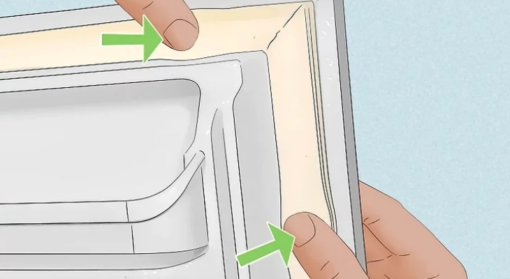 Đẩy miếng gioăng mới vào rãnh lõm trên cửa tủ lạnh